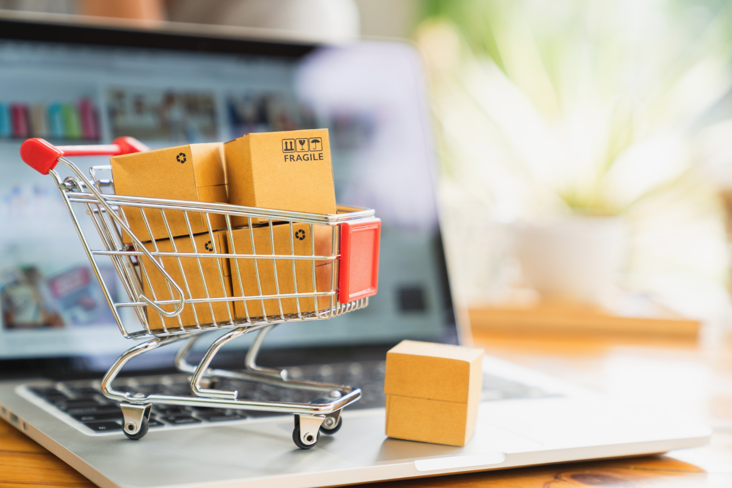 online-shopping-and-delivery-concept-product-package-boxes-in-cart-and-laptop.jpg